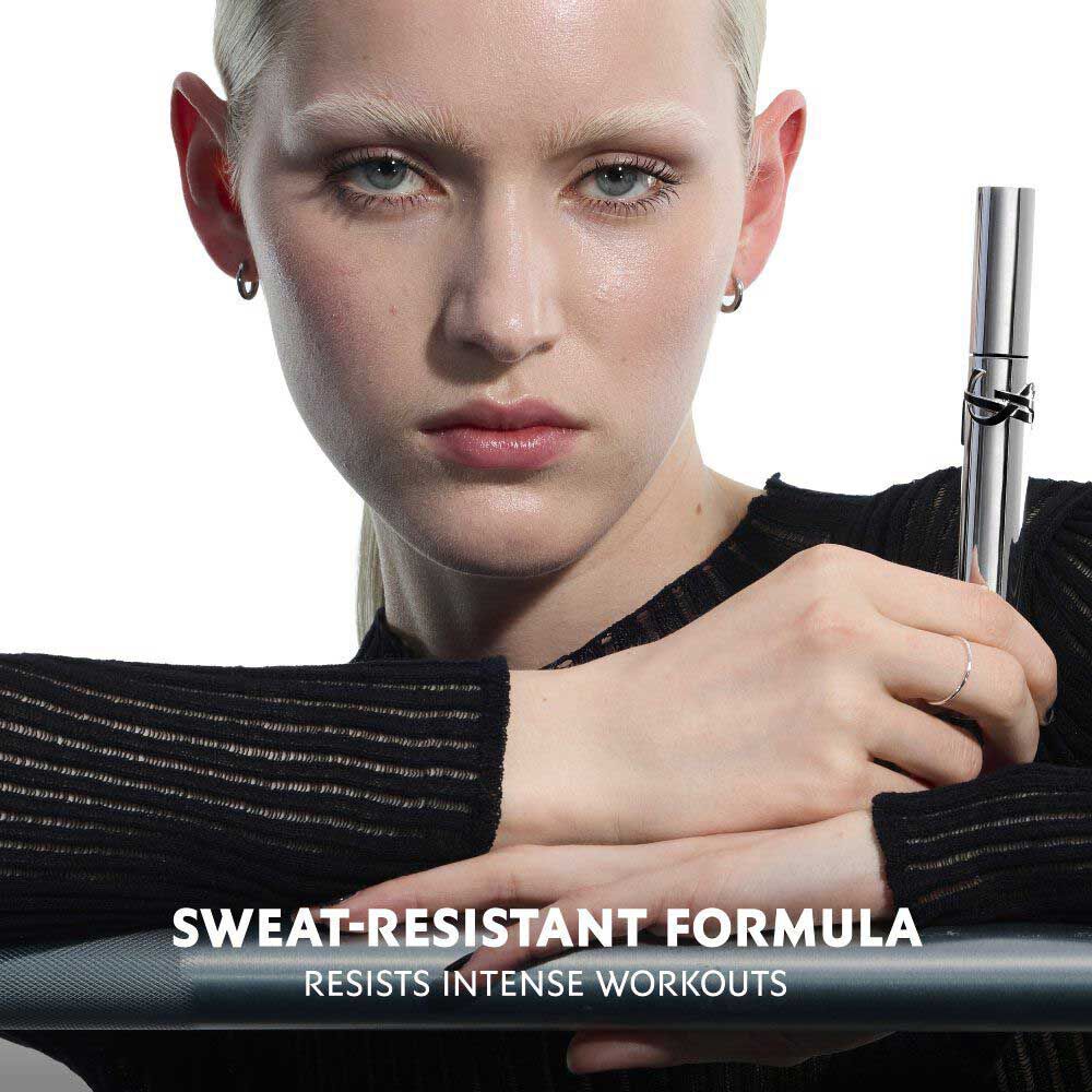 Close-up of model applying YSL Lash Latex Mascara with open wand.