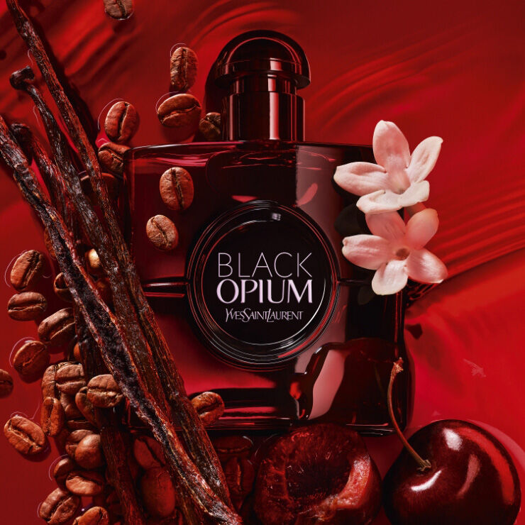 Black Opium Over Red perfume bottle surrounded by coffee beans, vanilla, and cherry notes