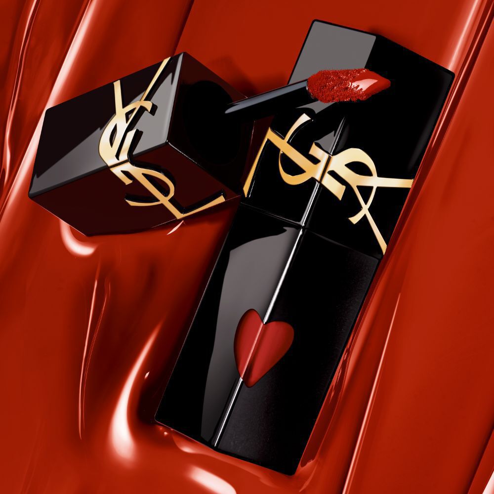 YSL The Inks Vinyl Cream lip stain collection arranged on a red background, showcasing the luxurious packaging