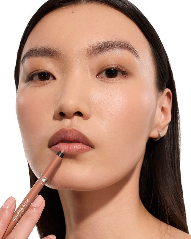 Jia Lu Yi wearing YSL LOVENUDE Kiss Shaper, shade 102, on light skin, holding the product.