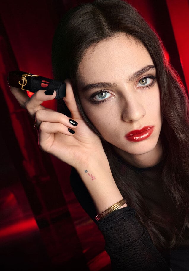 Model wearing YSL The Inks Vinyl Cream liquid lipstick in a bold red shade