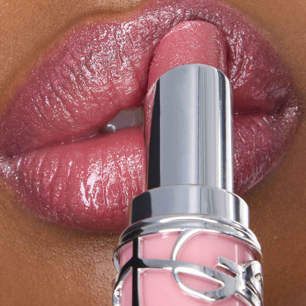 Najma applying YSL LOVESHINE Lipstick shade 215 to her shimmering lips, showcasing a radiant finish.