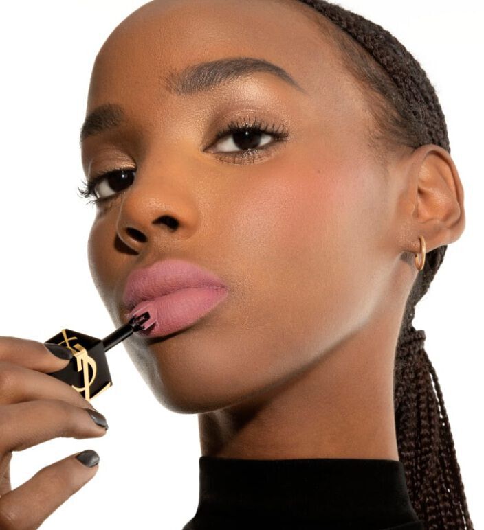 Model applying YSL The Inks Blur matte lip tint in soft pink shade 44 Nude Lavalliere