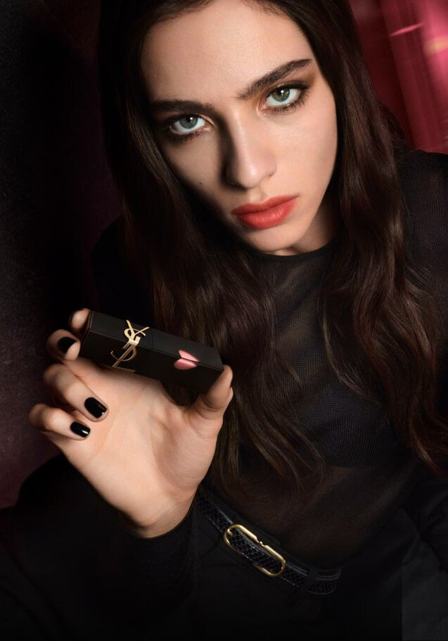Model holding YSL The Inks Blur matte lip tint showcasing a soft-blur lip makeup look
