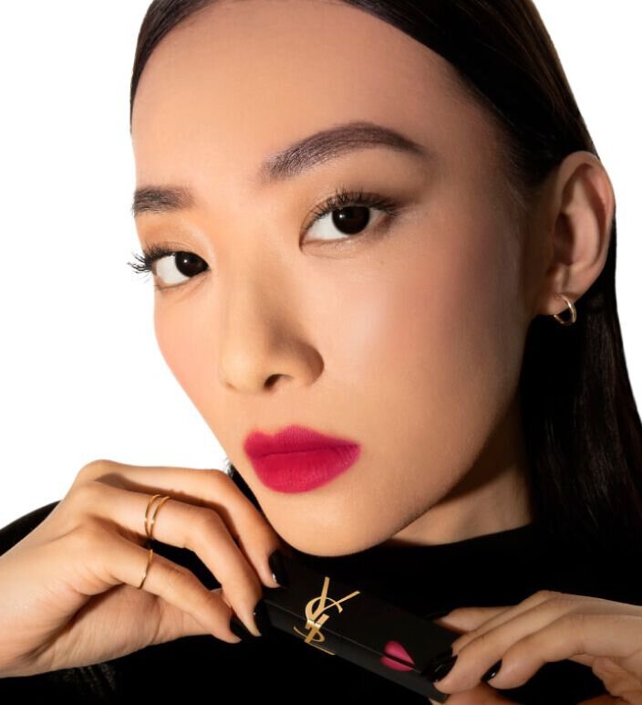 Model wearing YSL matte lip stain in vibrant red shade 236 Ruby Attraction