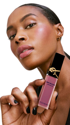 Model with deep skin tone wearing YSL Make Me Blush Liquid Blush in a bold berry shade