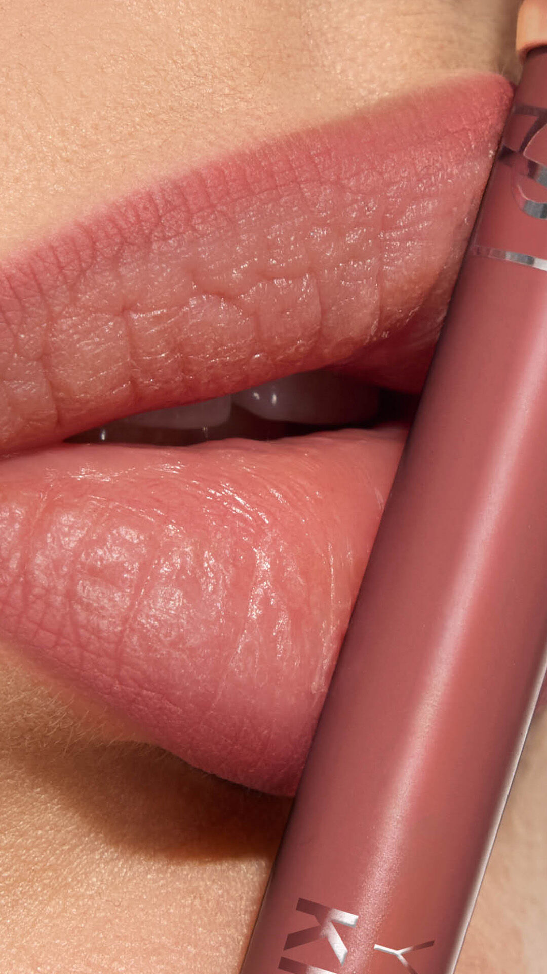 Adrienne's lips with YSL LOVENUDE Kiss Shaper 26 in Shade 44, a close-up showcasing the product.