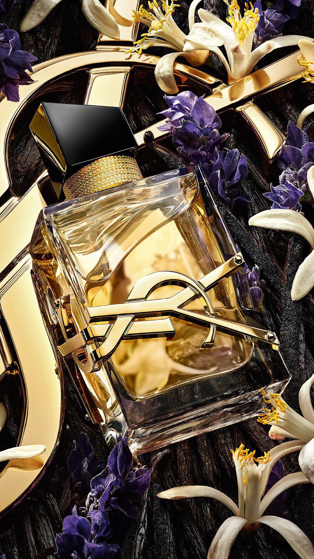Libre Eau de Toilette bottle with gold YSL logo on clear glass and pale juice.