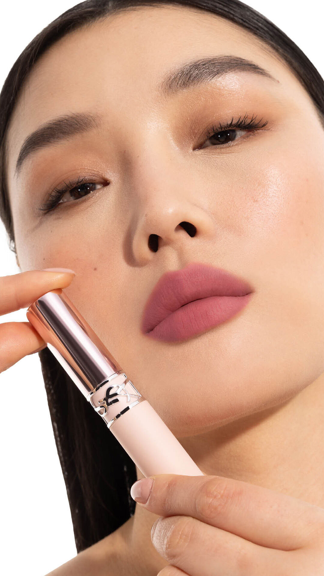 Jia Lu Yi applying YSL LOVENUDE Kiss Shaper 26 in Shade 110, full- face portrait on white background.