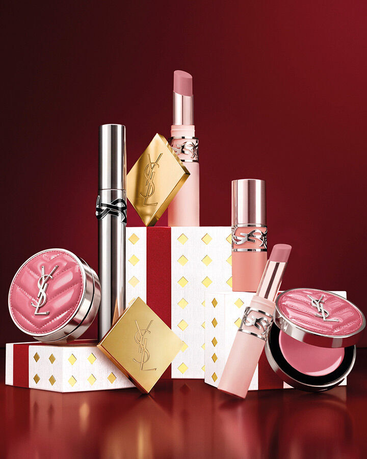 YSL Holiday makeup set featuring Loveshine gloss and Make Me Blush on festive pedestals