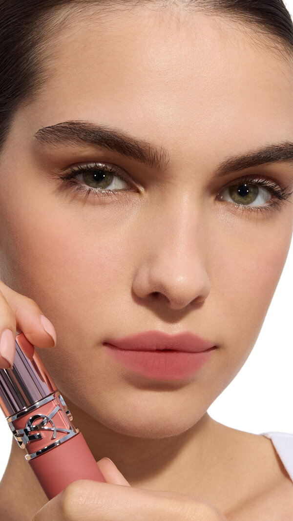Jia Lu Yi applying YSL LOVENUDE Kiss Shaper 26 in Shade 101, full- face portrait on white background.