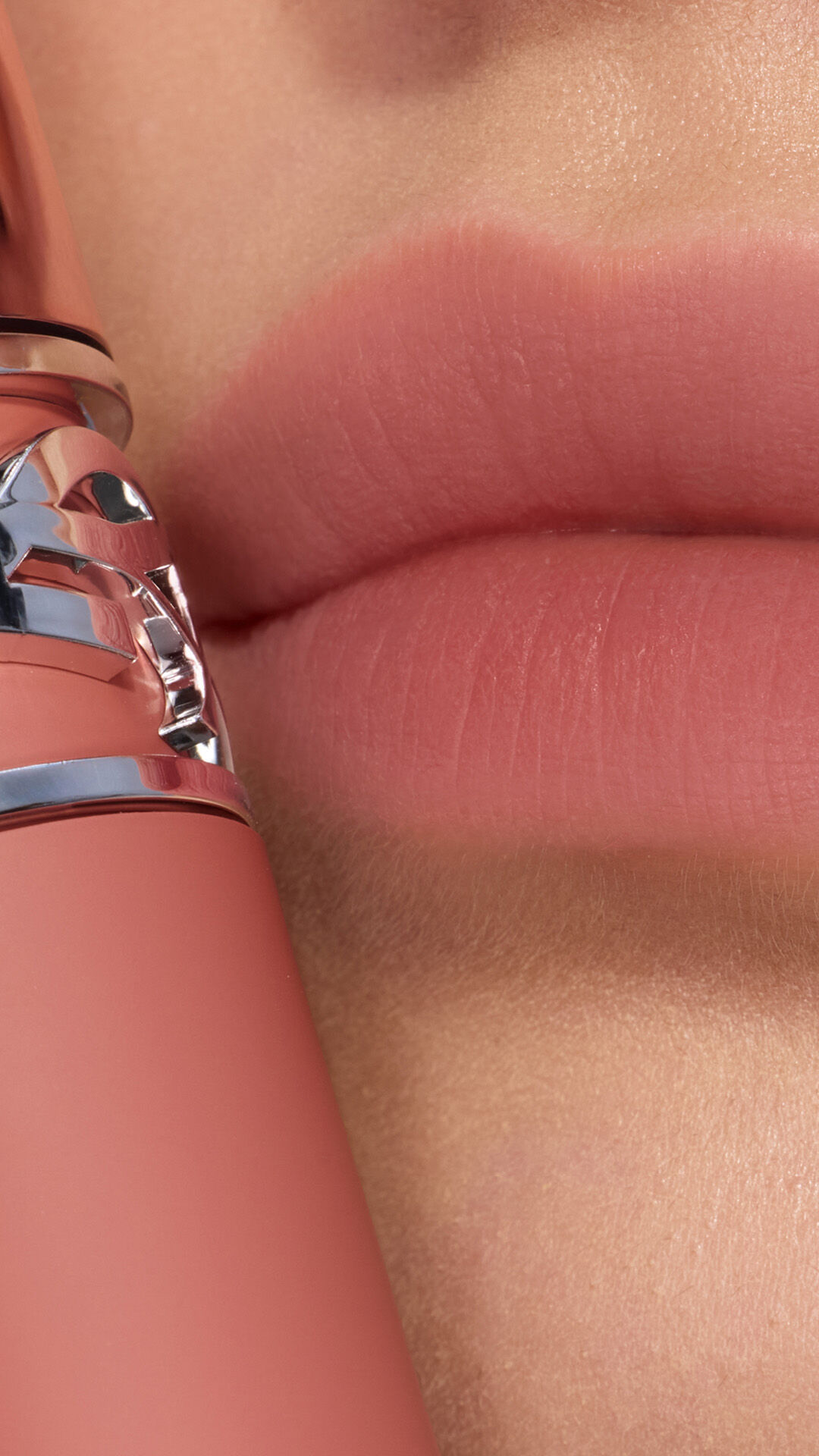 Ehlana applying YSL LOVENUDE Kiss Shaper 26 in Shade 103, a close- up of her lips.