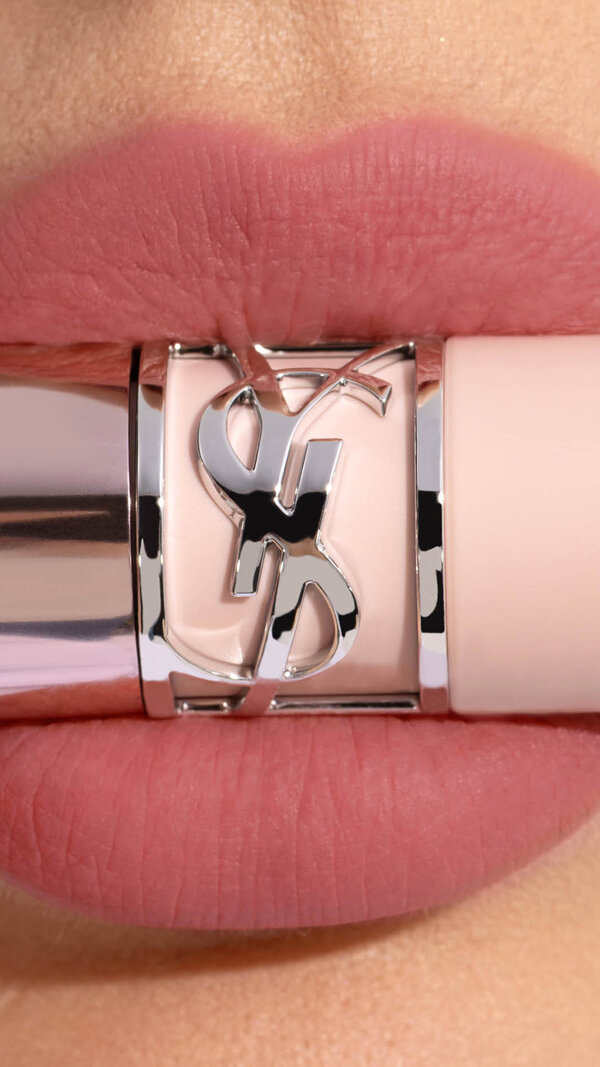 Ehlana applying YSL LOVENUDE Kiss Shaper 26 in Shade 110, a close- up of her lips.