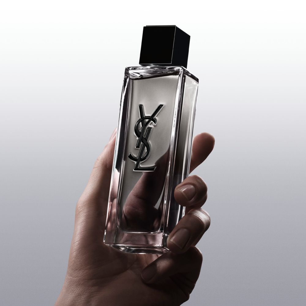 Hand holding the MYSLF Eau de Toilette Intense bottle to demonstrate the grip and design.