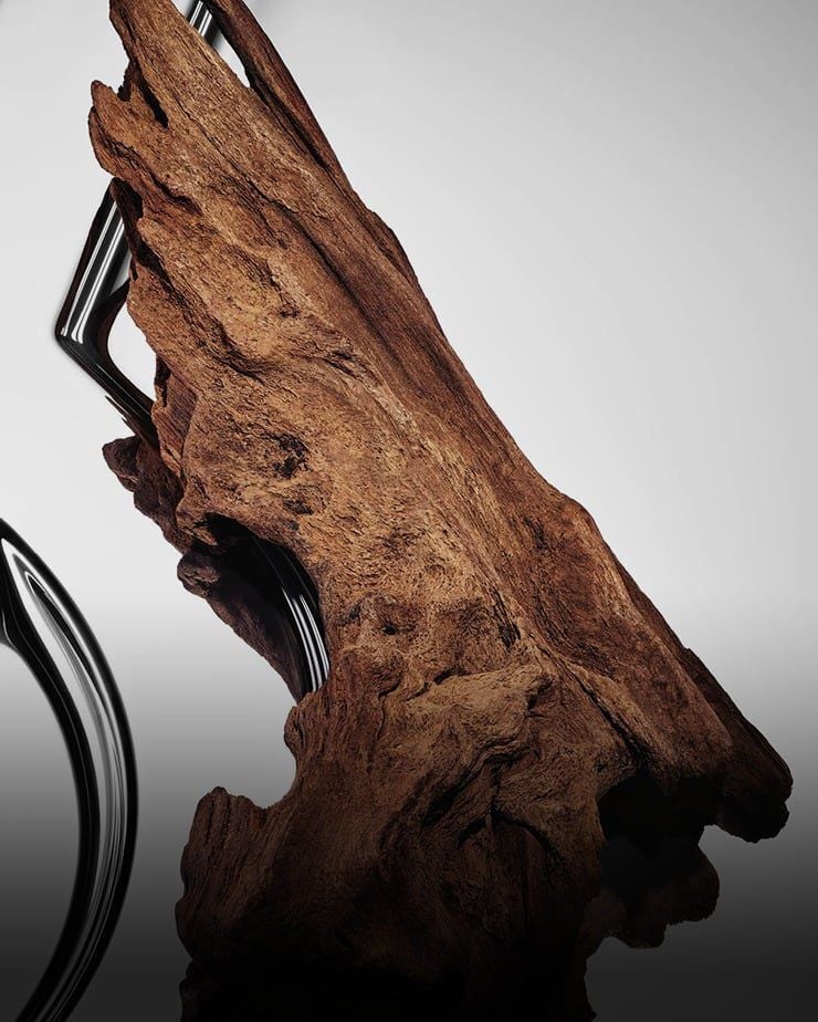 Textured warm sensual woods on a reflective YSL Cassandre background.