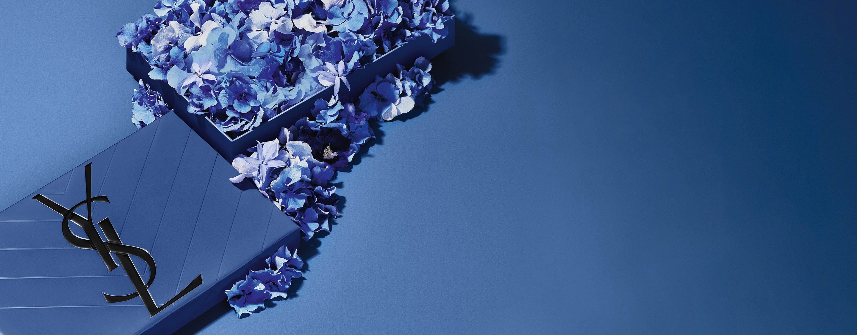 YSL Father's Day blue gift set, featuring the iconic
Cassandre logo, overflowing with delicate blue floral
accents.