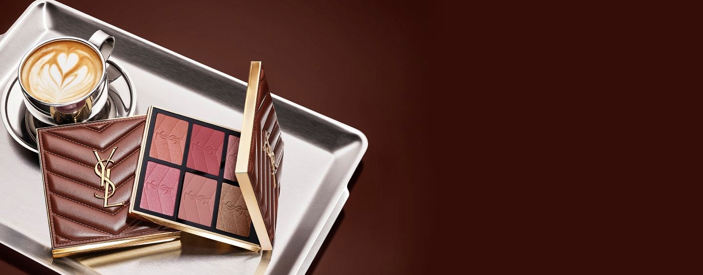 YSL Fall Drop latte makeup collection with Loveshine Lip Oil, Face Palette and Make Me Blush and a cup of coffee on a silver tray
