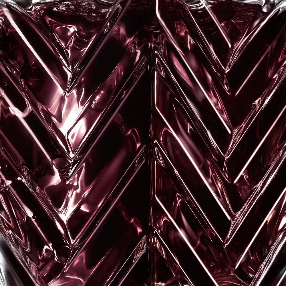 YSL LVDP Muse Extrait de Parfum 50ml bottle, close-up of deep red glass chevron texture
