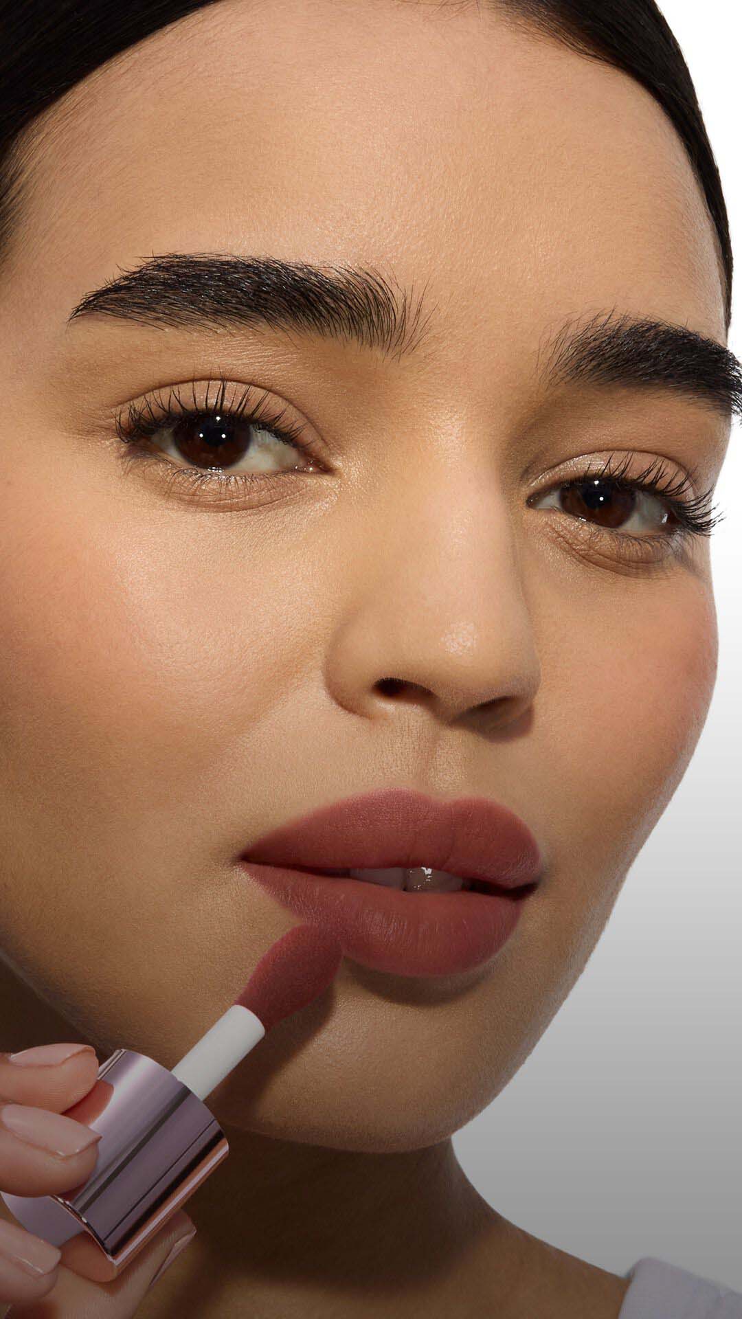 Close-up of a model's cheek wearing the Make Me Blush routine: Powder #66 Fuchsia Fizz layered with Cream #86 Raspberry Glaze for a vibrant, juicy finish.