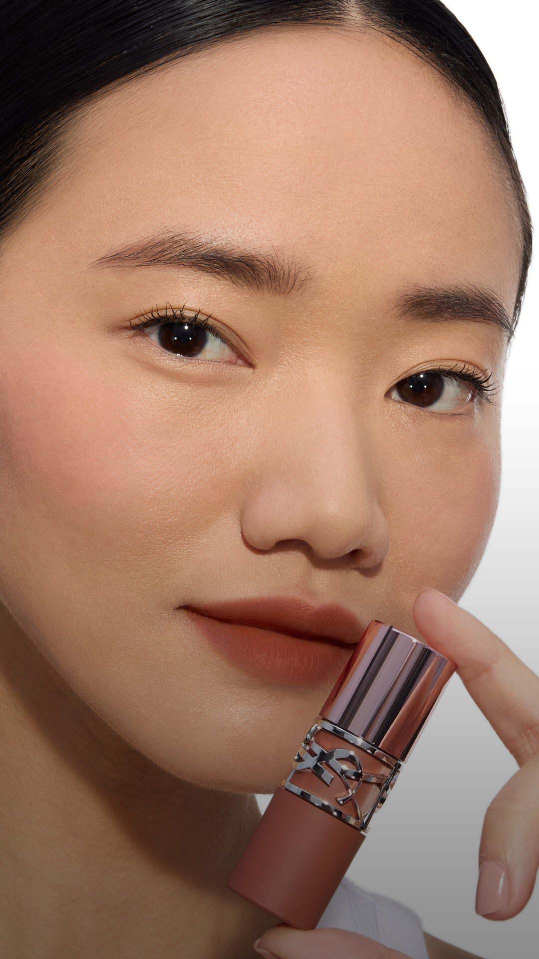 Close-up of a model's cheek wearing the Make Me Blush routine: Powder #54 Berry Bang layered with Cream #44 Nude Lavallière for a vibrant, custom pink statement.